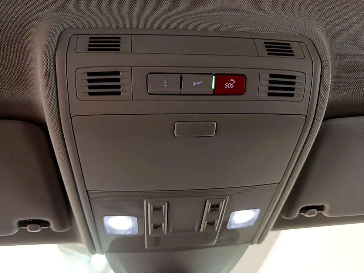 Plafonnier intérieur avec commandes SOS et éclairages LED allumés dans un Volkswagen Taigo noir, vue de dessous.