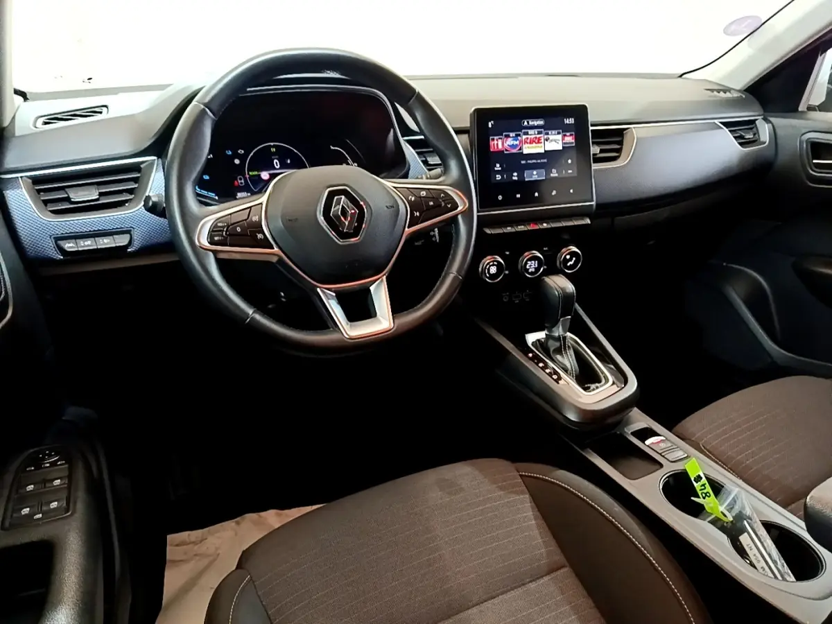 Vue intérieure côté conducteur du tableau de bord et volant cuir du Renault Arkana Evolution E-Tech 2023.