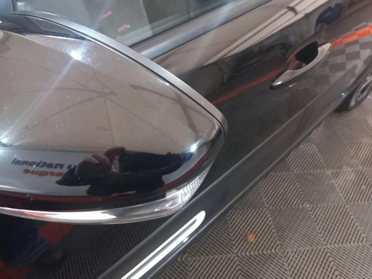 Rétroviseur droit noir brillant avec clignotant intégré sur la porte avant droite d'une Citroën C3 noire 2024.