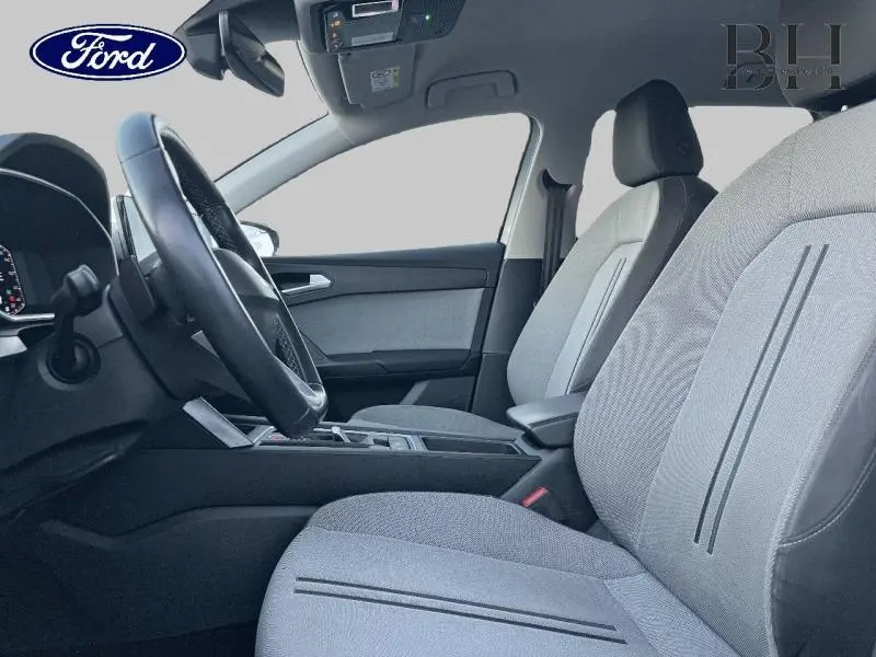 Intérieur avant de la SEAT LEON ST 1.0 eTSI 110ch Urban 2022, sièges tissu gris et volant cuir multifonction.
