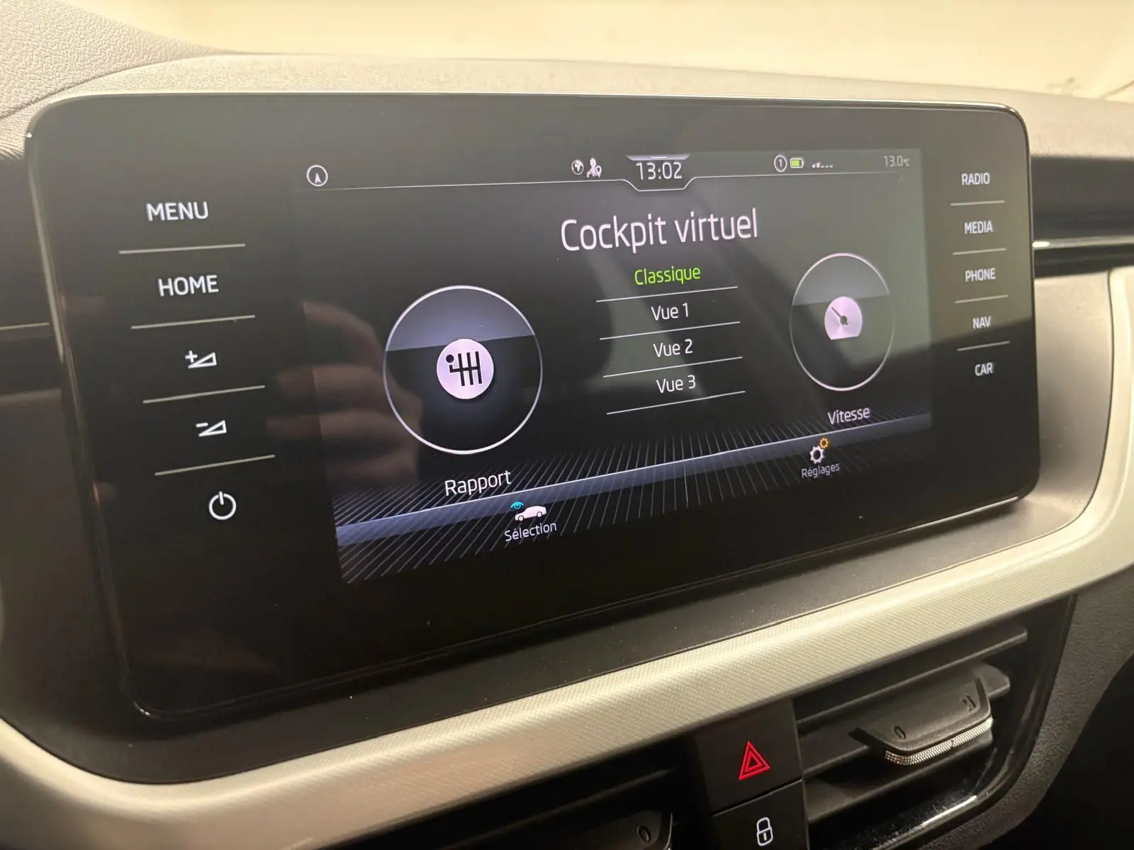 Écran tactile central du Skoda Kamiq 2023 affichant le cockpit virtuel, avec commandes et finition intérieure gris clair.