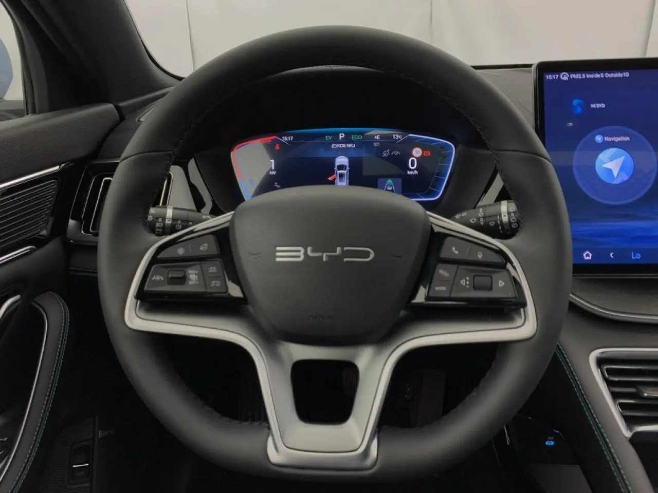 Vue intérieure centrée sur le volant BYD Seal U 2025 en similicuir noir avec tableau de bord numérique et écran tactile.