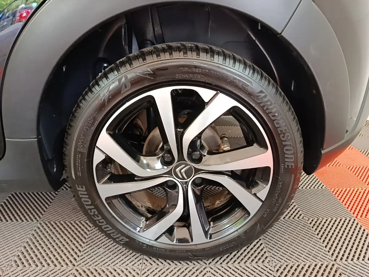 Gros plan sur la roue avant droite noire et argentée d'une Citroën C3 2022, avec logo Citroën central visible.
