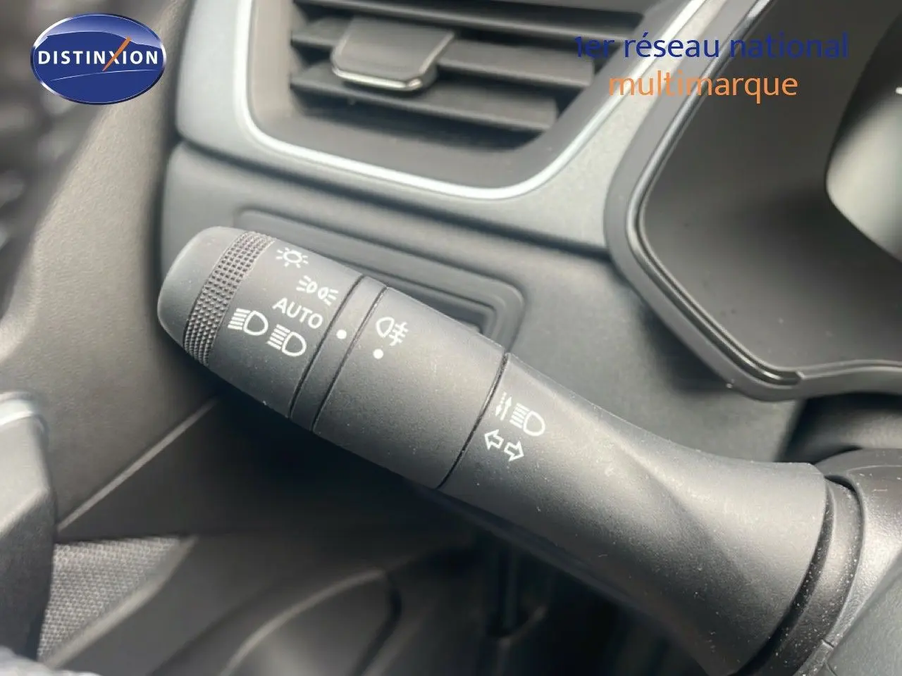 Gros plan sur la commande des phares et clignotants dans l'habitacle du Renault Captur noir étoile métal 2025.