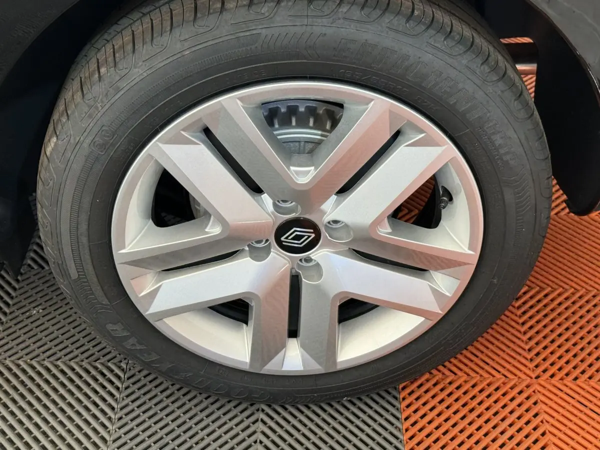 Gros plan sur la jante argentée de la Renault Clio noire Evolution Blue dCi 100, montrant le logo central stylisé.