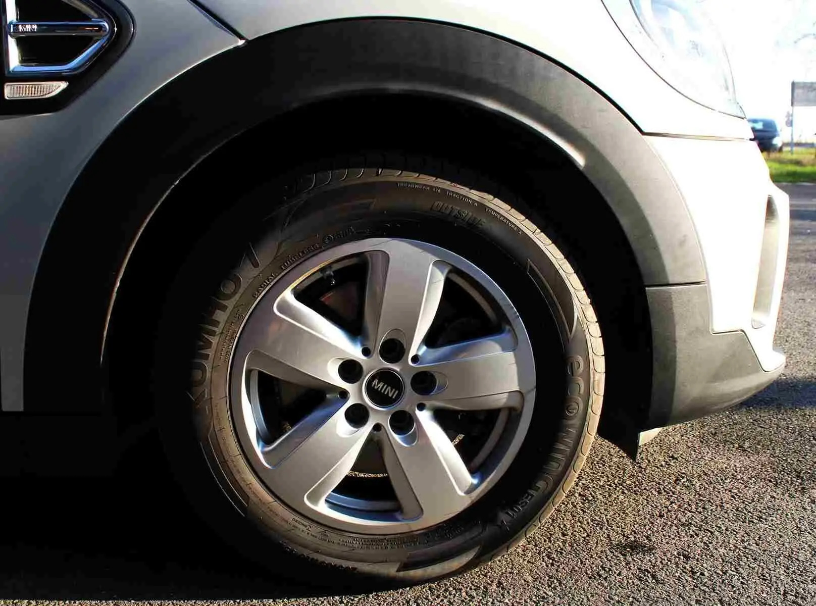 Gros plan sur la roue avant droite d’un MINI Countryman gris perle métal avec jante alliage cinq branches.