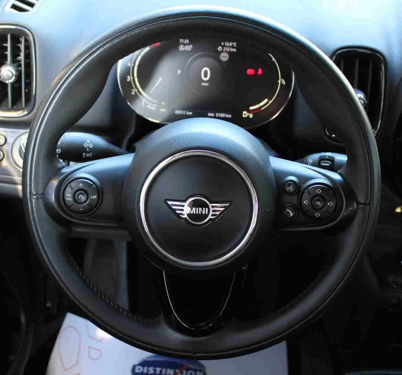 Vue rapprochée du volant en cuir noir de la MINI Countryman 2020 avec tableau de bord digital allumé.