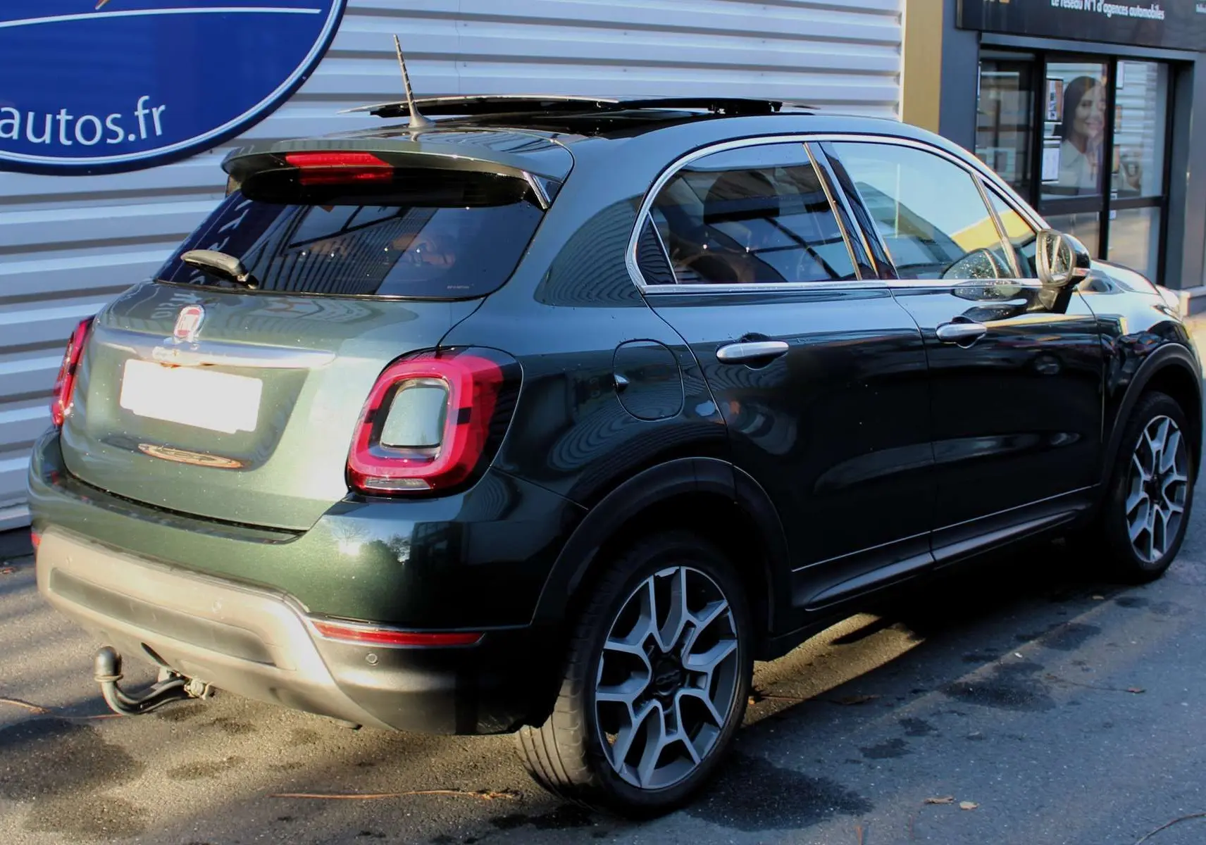 Fiat 500X vert Toscane métal vue 3/4 arrière droit avec attelage et jantes biton de 16 pouces.