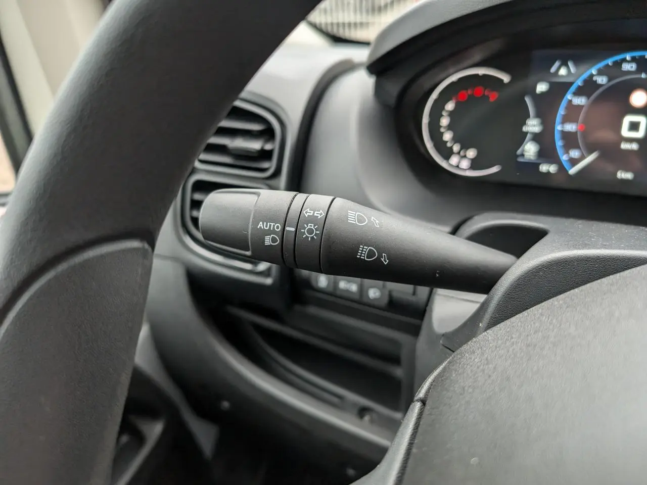 Gros plan sur la commande des phares automatiques et clignotants dans l'habitacle du Citroën Jumper 2025.