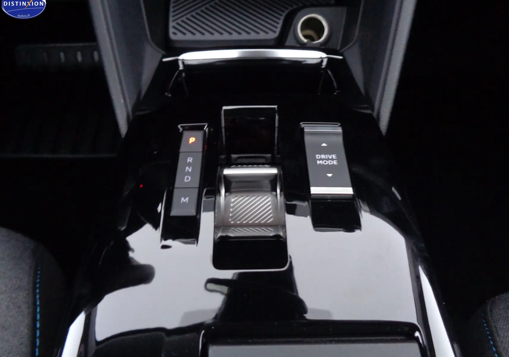 Gros plan sur la console centrale noire brillante avec levier de vitesses automatique et bouton Drive Mode du Citroën C4 X 2023.