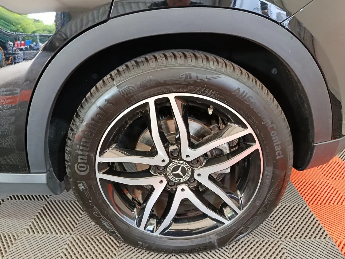 Gros plan sur la roue avant droite noire du Mercedes GLA 220 d avec jante alliage bicolore et pneu Continental.