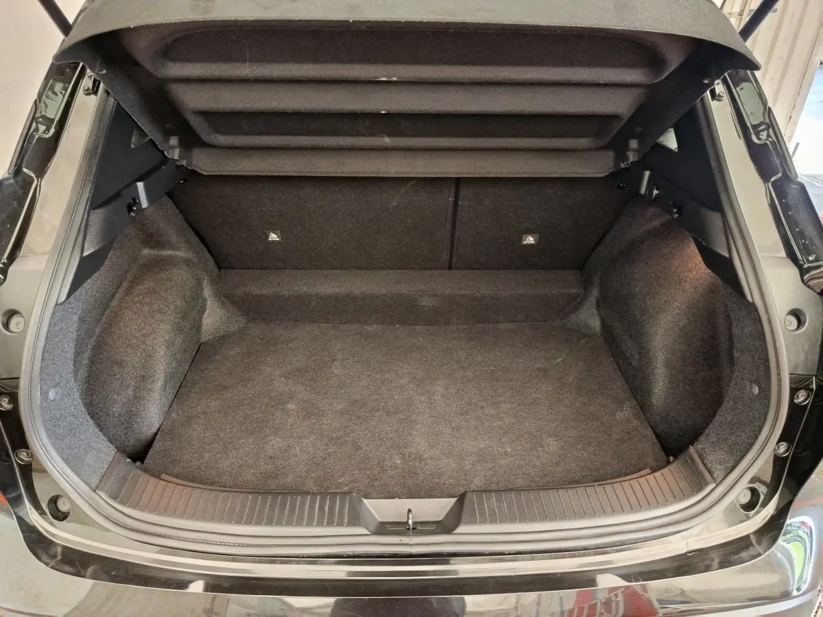 Coffre ouvert noir du Nissan Qashqai e-Power 190 Business Edition BVA, vue arrière montrant l'espace de chargement vide.