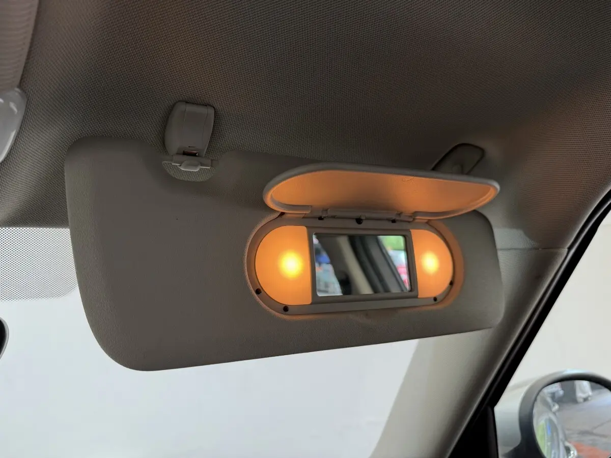 Miroir de courtoisie éclairé sur pare-soleil côté conducteur dans l’habitacle gris clair d’un MINI Countryman 2023.
