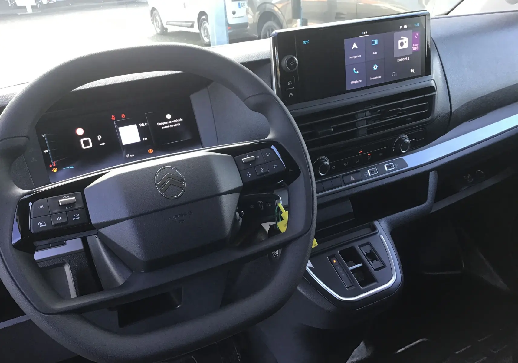 Vue rapprochée de l'intérieur du Citroën Jumpy XL gris titane, tableau de bord et volant multifonctions avec écran tactile.