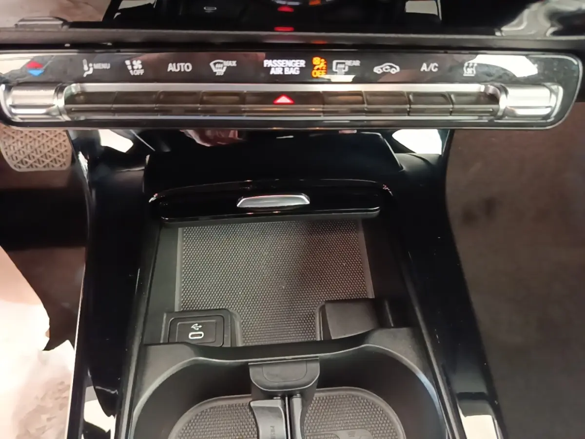 Vue rapprochée de la console centrale noire du Mercedes Classe A 250 e Business Line 2023 avec commandes climatisation et pavé tactile.