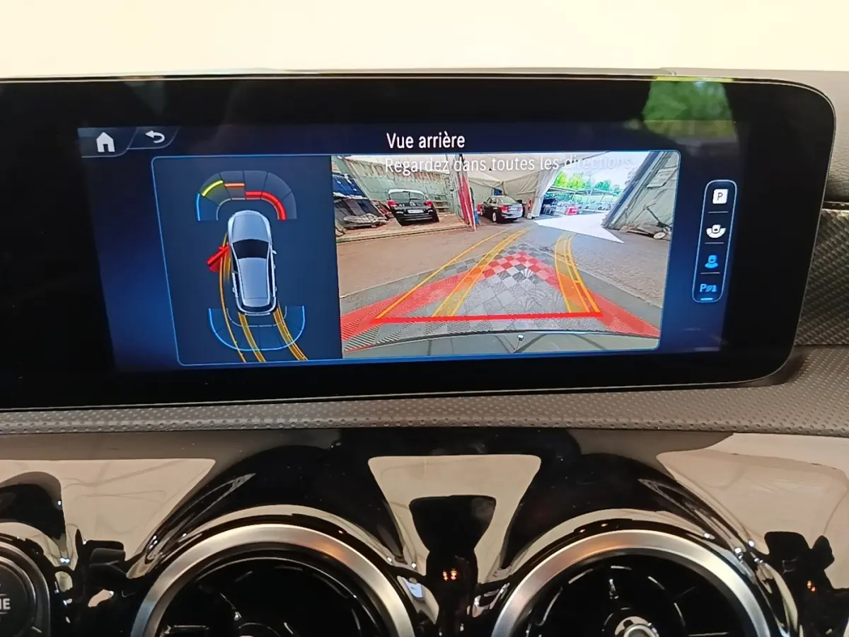Écran tactile intérieur affichant la caméra de recul et l’aide au stationnement de la Mercedes Classe A noire 2023.