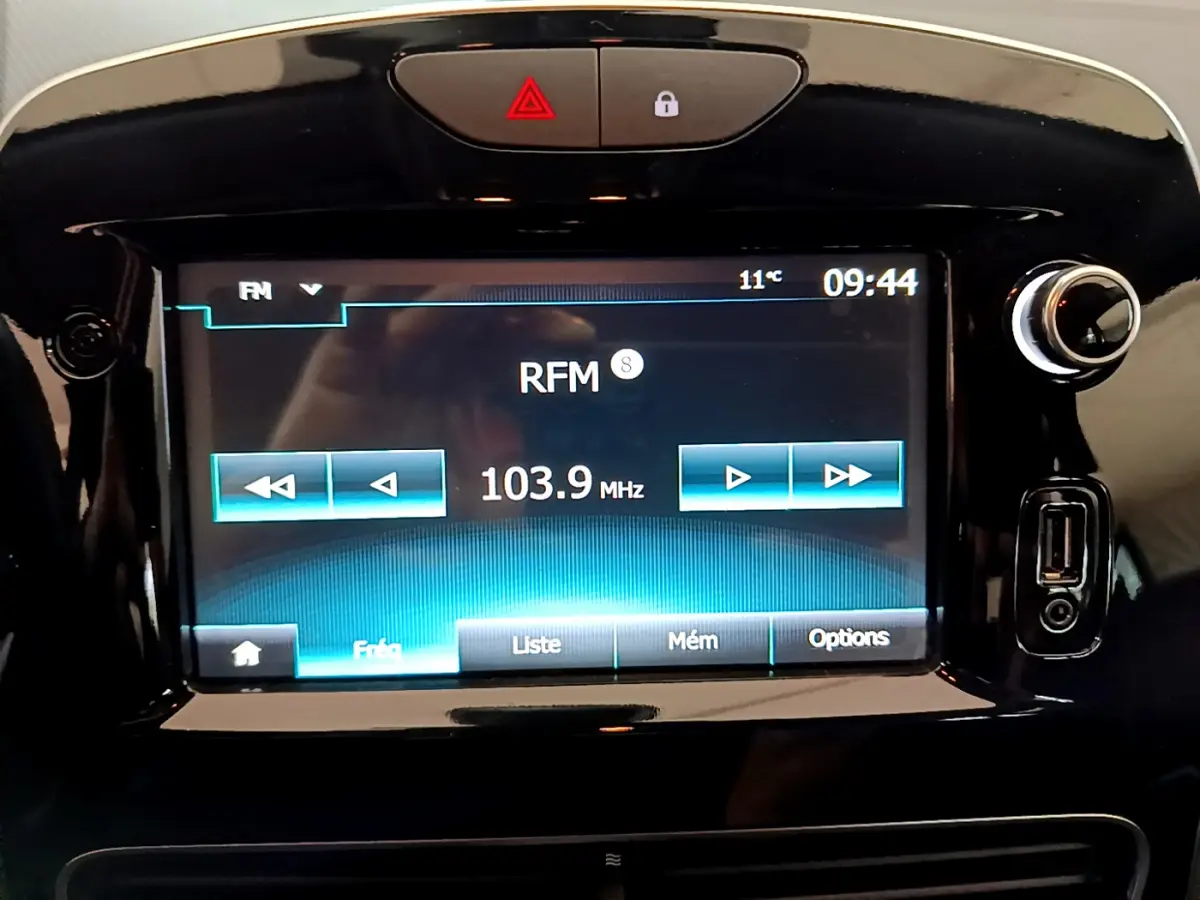Écran tactile central allumé de la Renault Clio Business TCe 90 2019, affichant la radio sur fond noir brillant.
