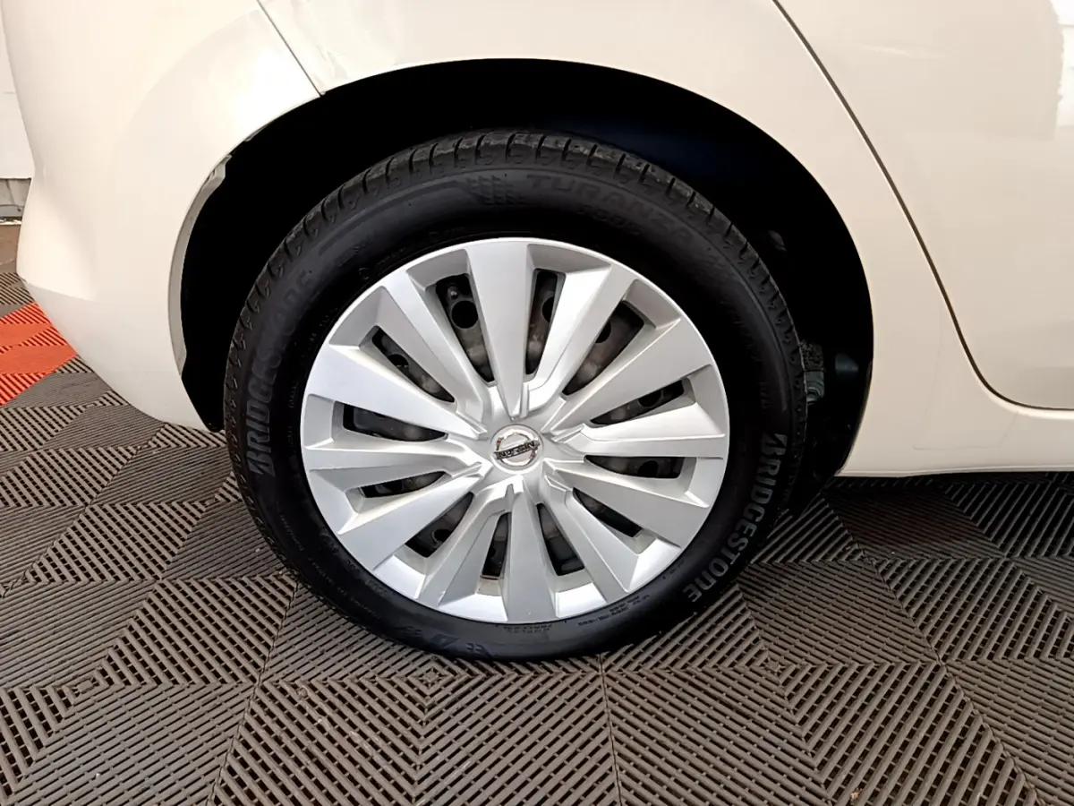 Gros plan sur la roue arrière droite d'une Nissan Micra blanche 2022 avec enjoliveur argenté et pneu Bridgestone.