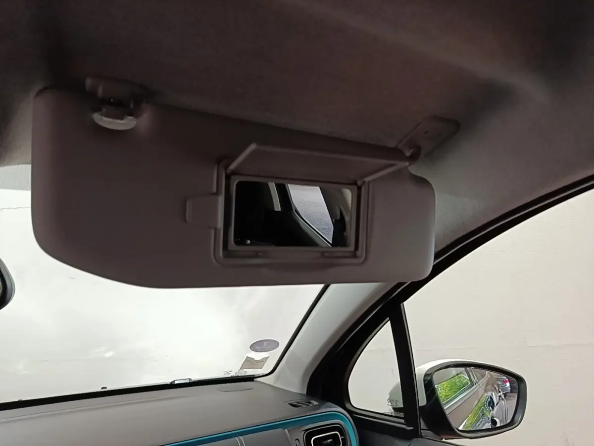 Intérieur de la Citroën C3 PureTech 110 2022, vue du pare-soleil côté conducteur avec miroir et rétroviseur noir visible.
