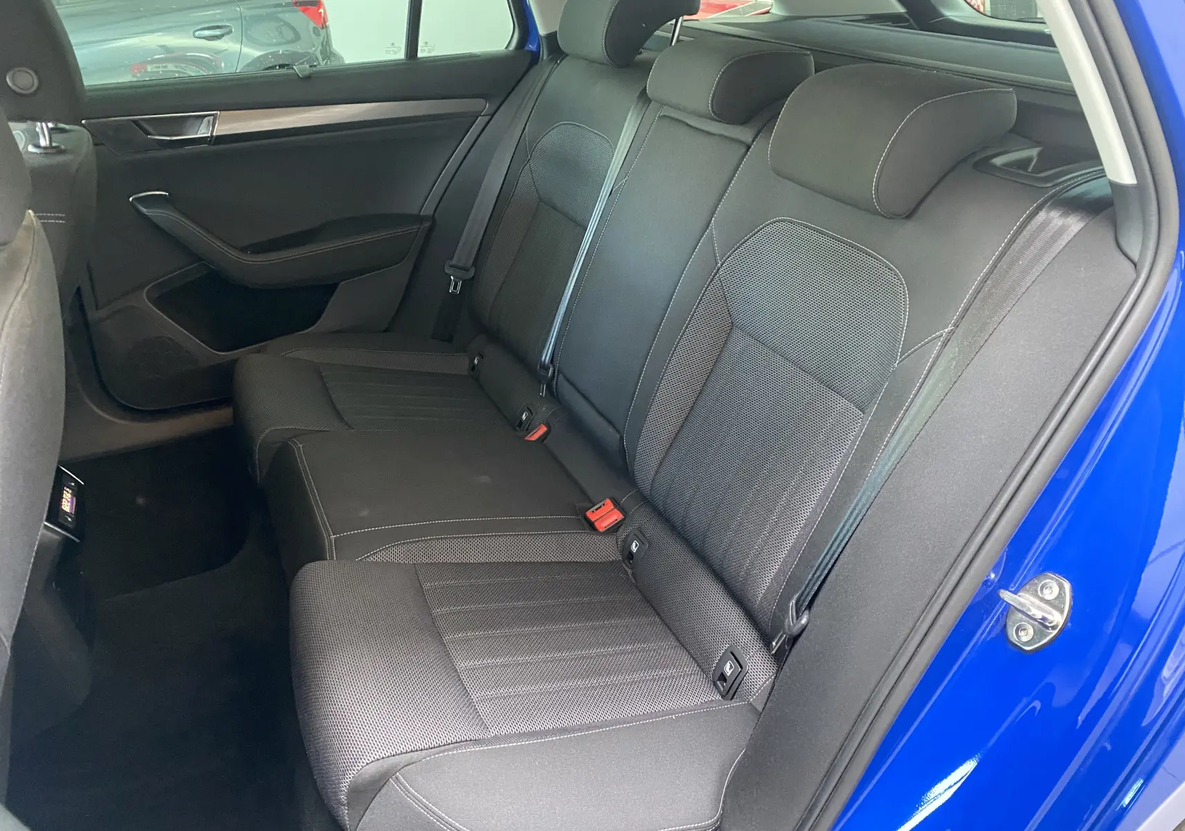 Vue intérieure côté droit des sièges arrière noirs en tissu de la Skoda Superb Combi bleu énergie 2020.