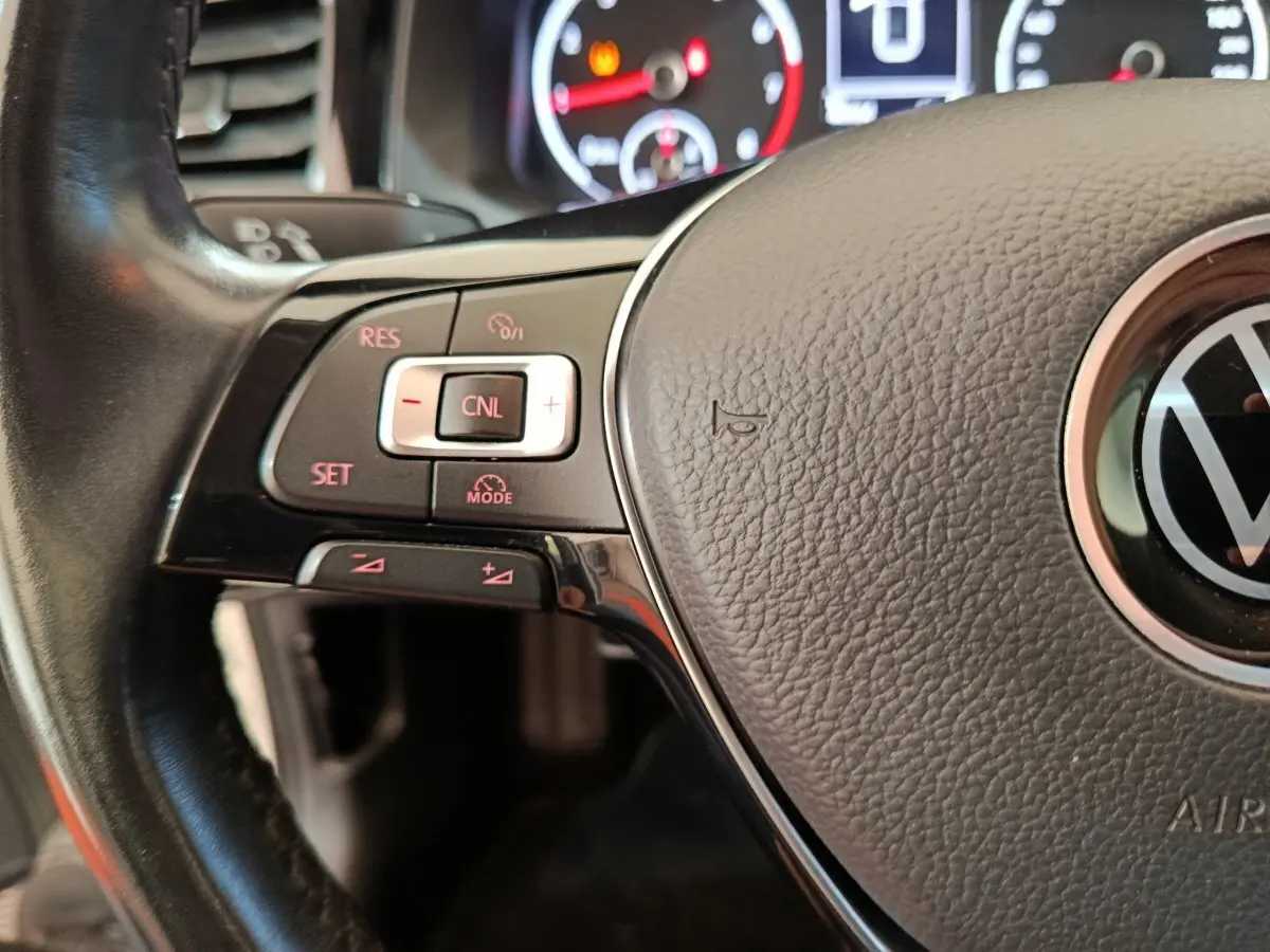 Gros plan sur le volant cuir noir de la Volkswagen Polo 2020 avec commandes intégrées et logo VW central visible.