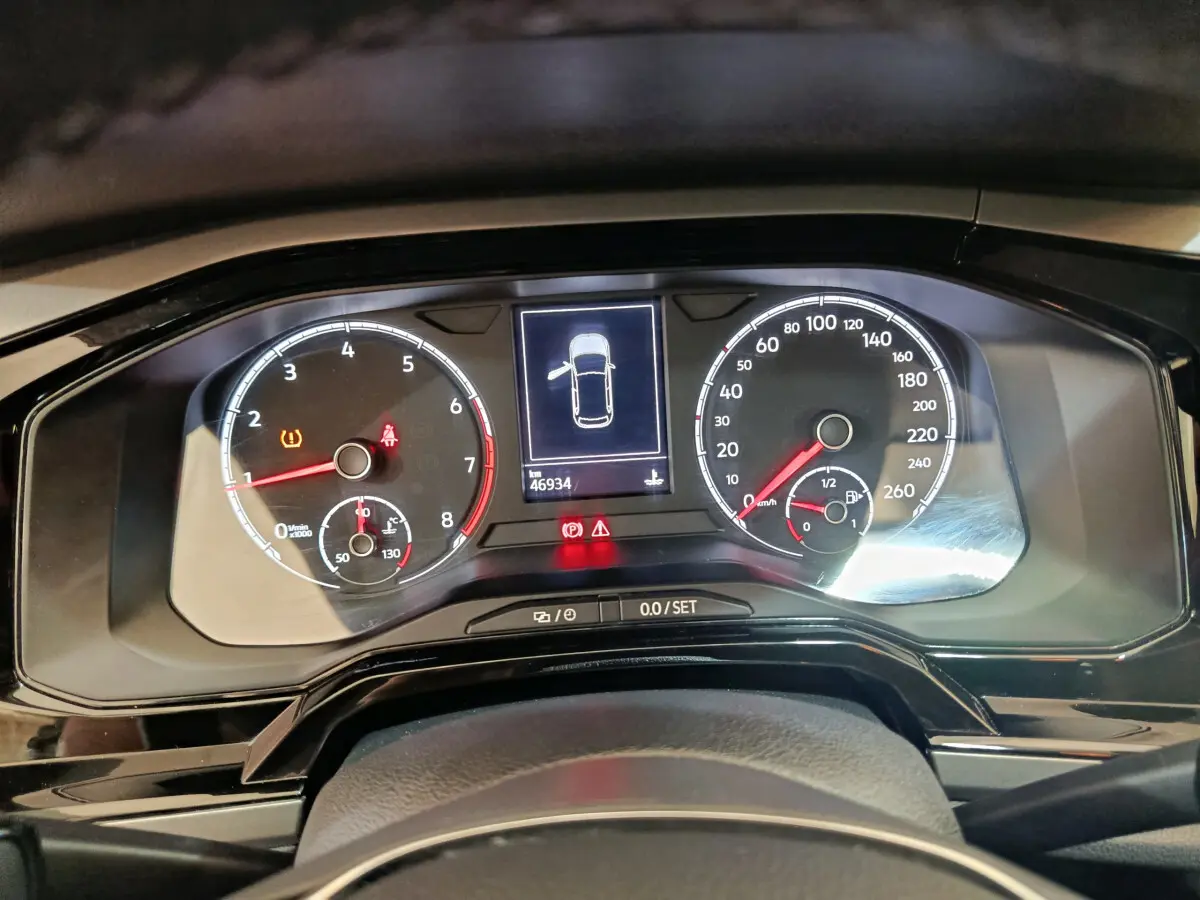 Tableau de bord numérique de Volkswagen Polo 2020 avec compte-tours, vitesse et écran central affichant porte ouverte.