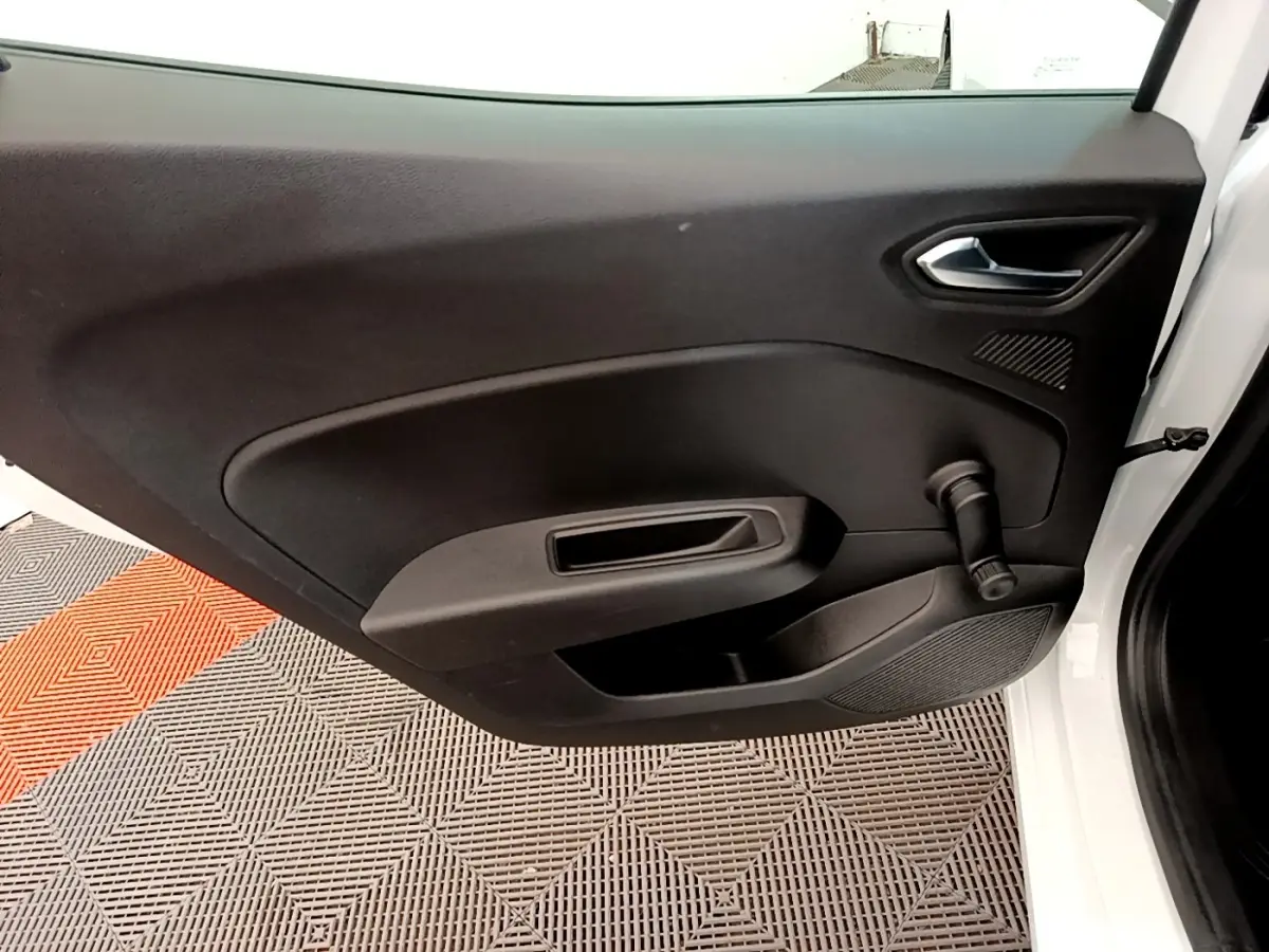 Vue intérieure de la porte avant droite blanche de la Renault Clio Business Blue dCi 85 avec poignée de vitre manuelle noire.