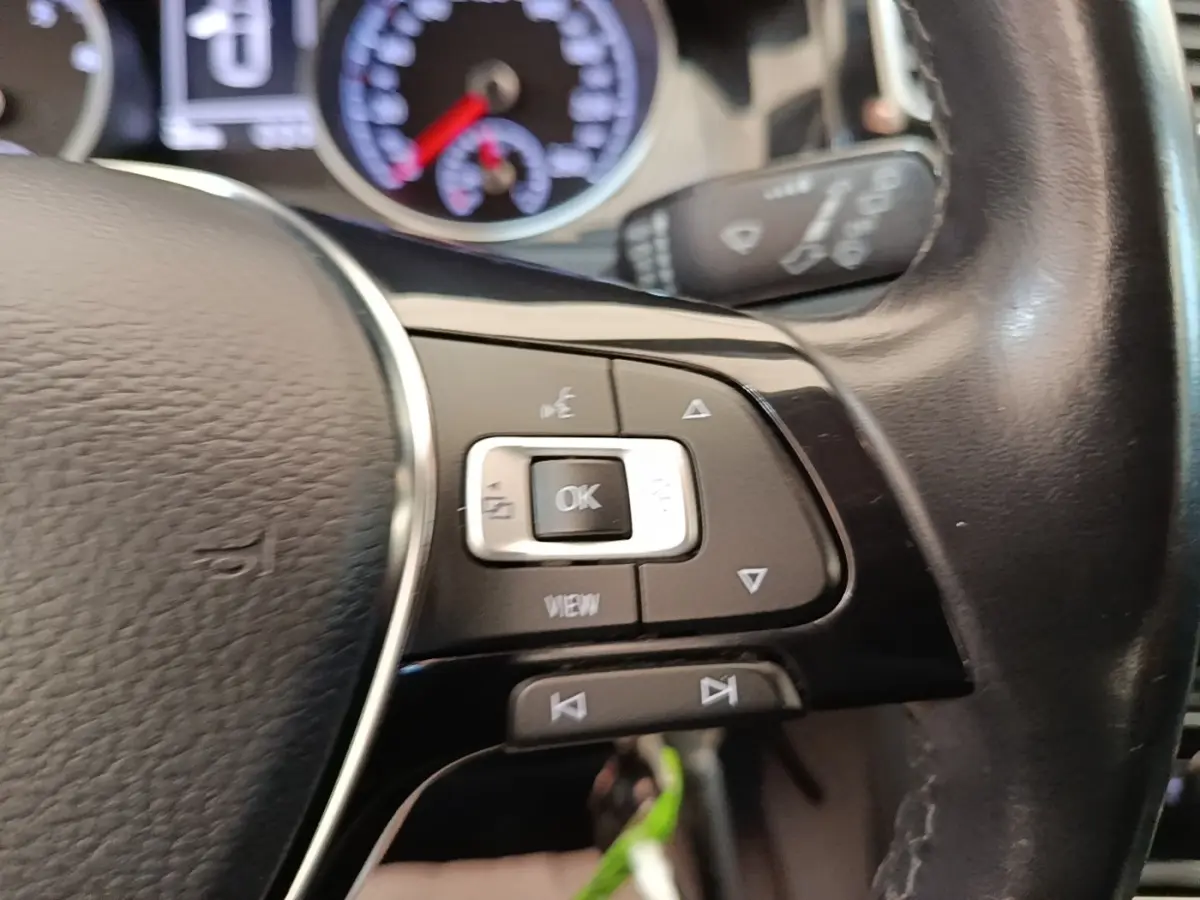Gros plan sur le volant cuir multifonctions côté gauche d’une Volkswagen Golf 2020 avec commandes intégrées.