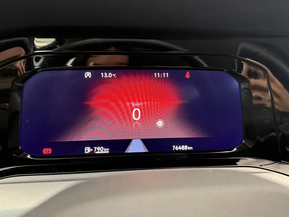 Affichage numérique du tableau de bord de la Volkswagen Golf bleu, montrant la vitesse à 0 km/h et l'autonomie restante.