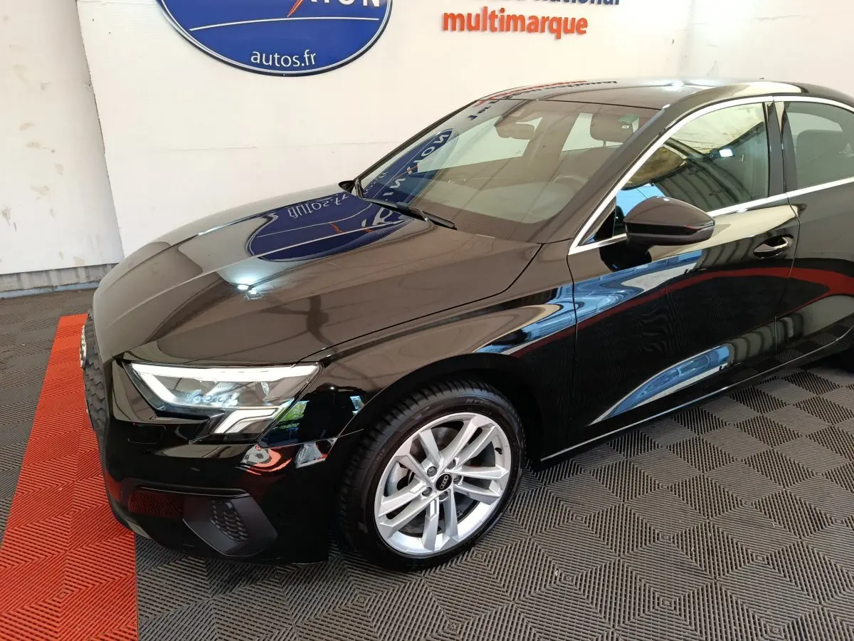 Audi A3 noir vue 3/4 avant droit, mettant en valeur ses phares LED et jantes alliage argentées.