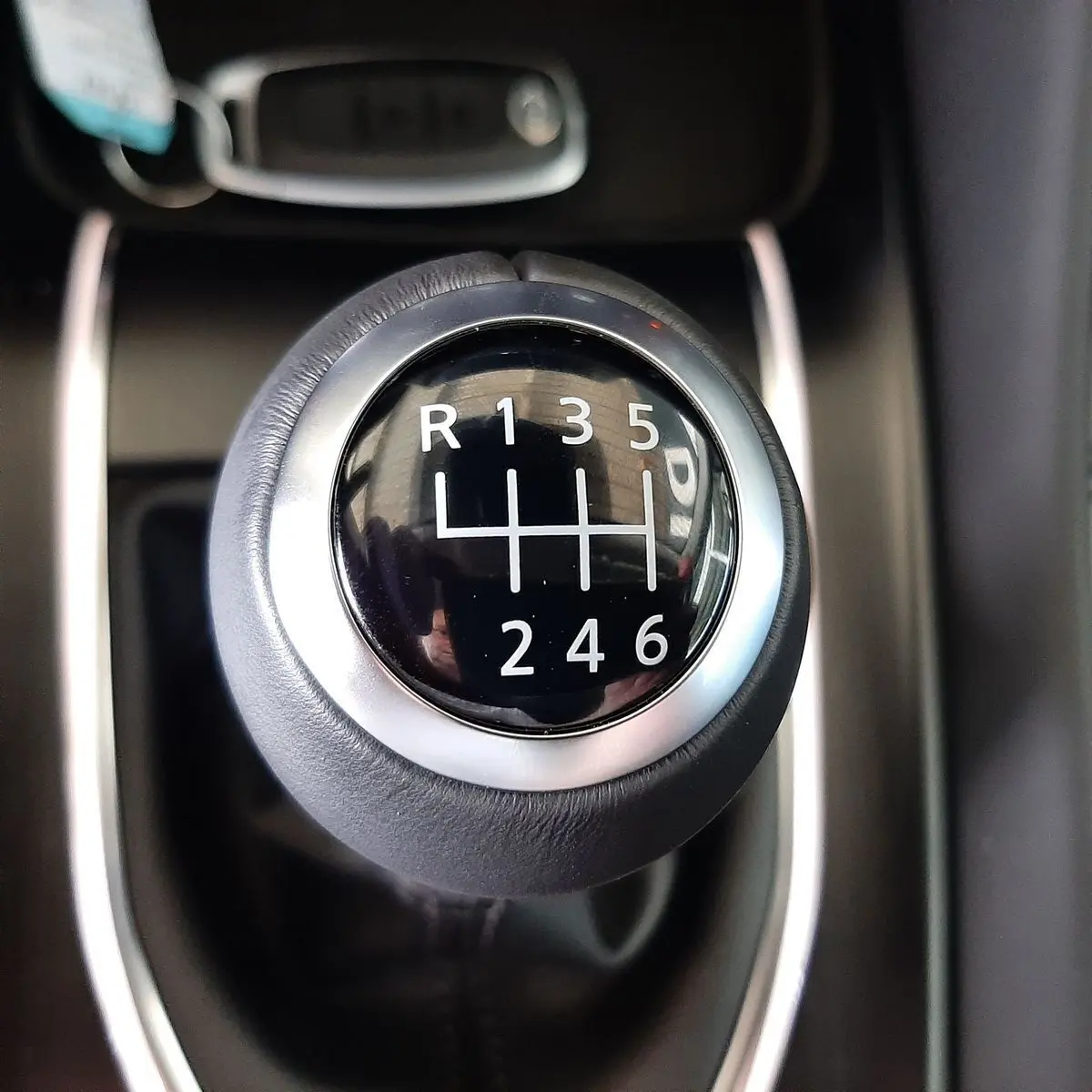 Gros plan sur le levier de vitesses manuel noir et argent du Nissan Qashqai blanc lunaire 2022.