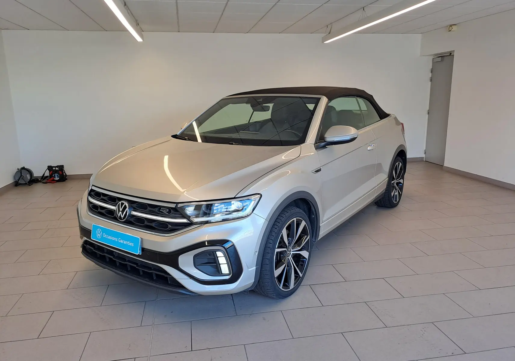 Volkswagen T-Roc Cabriolet gris ivoire vue 3/4 avant avec capote noire et jantes alliage 19 pouces Misano.