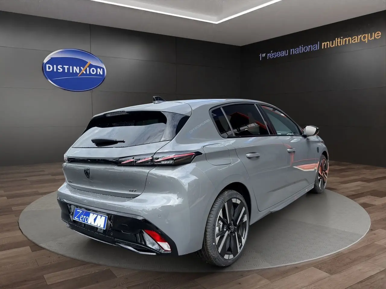 Vue 3/4 arrière droite d'une Peugeot 308 GT gris selenium avec jantes alliage bi-ton et feux arrière LED distinctifs.