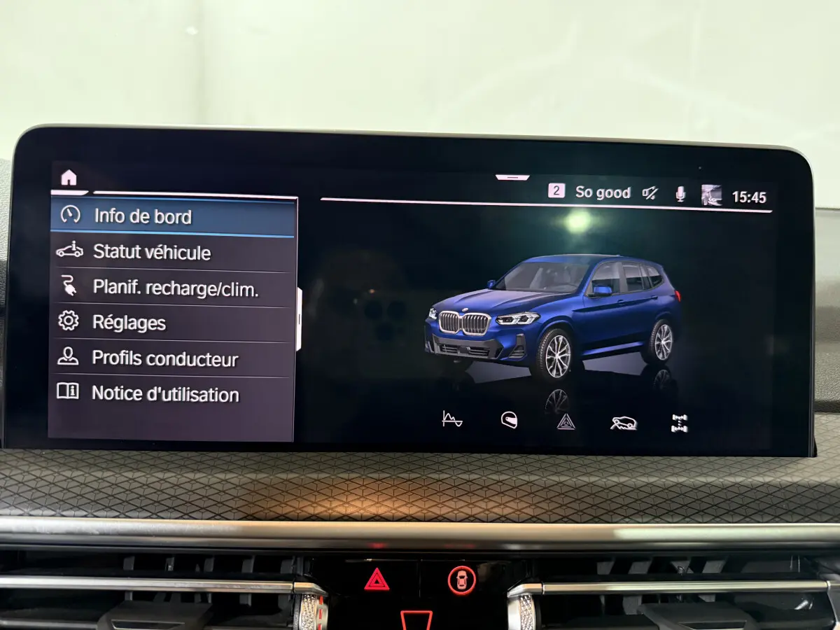 Écran tactile central affichant un BMW X3 bleu en 3/4 avant droit dans le menu d'info de bord.