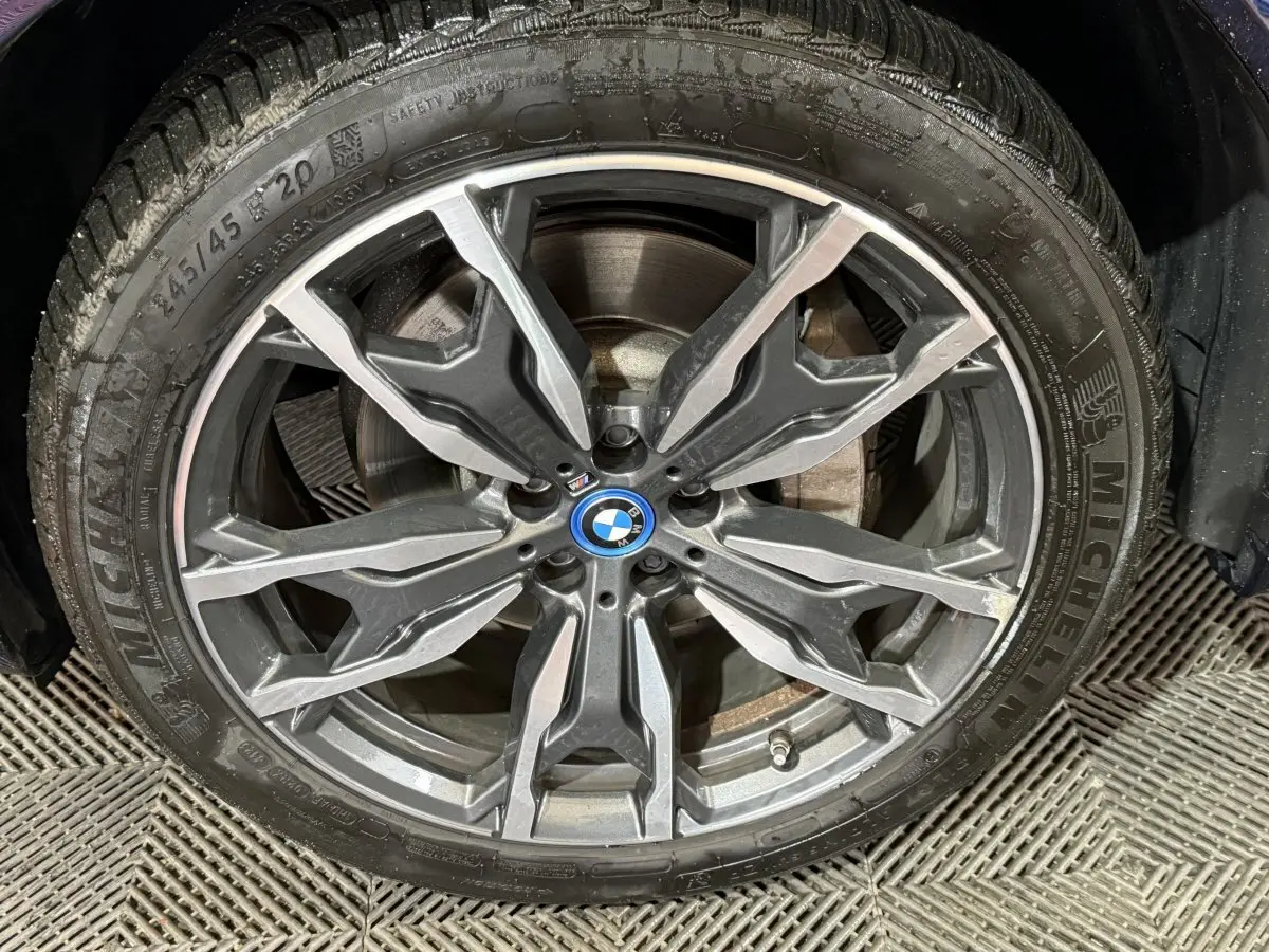 Gros plan sur la jante alliage BMW M Sport avec pneu Michelin, détails du disque de frein visibles.