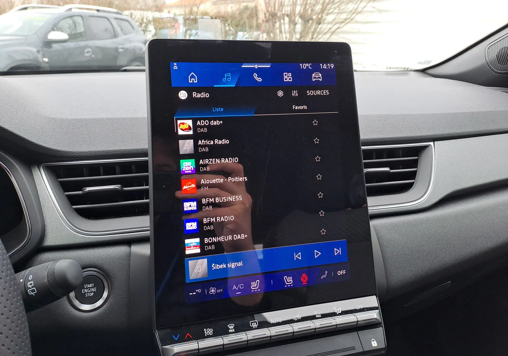 Vue intérieure du tableau de bord de la Renault Symbioz 2025, écran tactile central affichant les radios DAB.