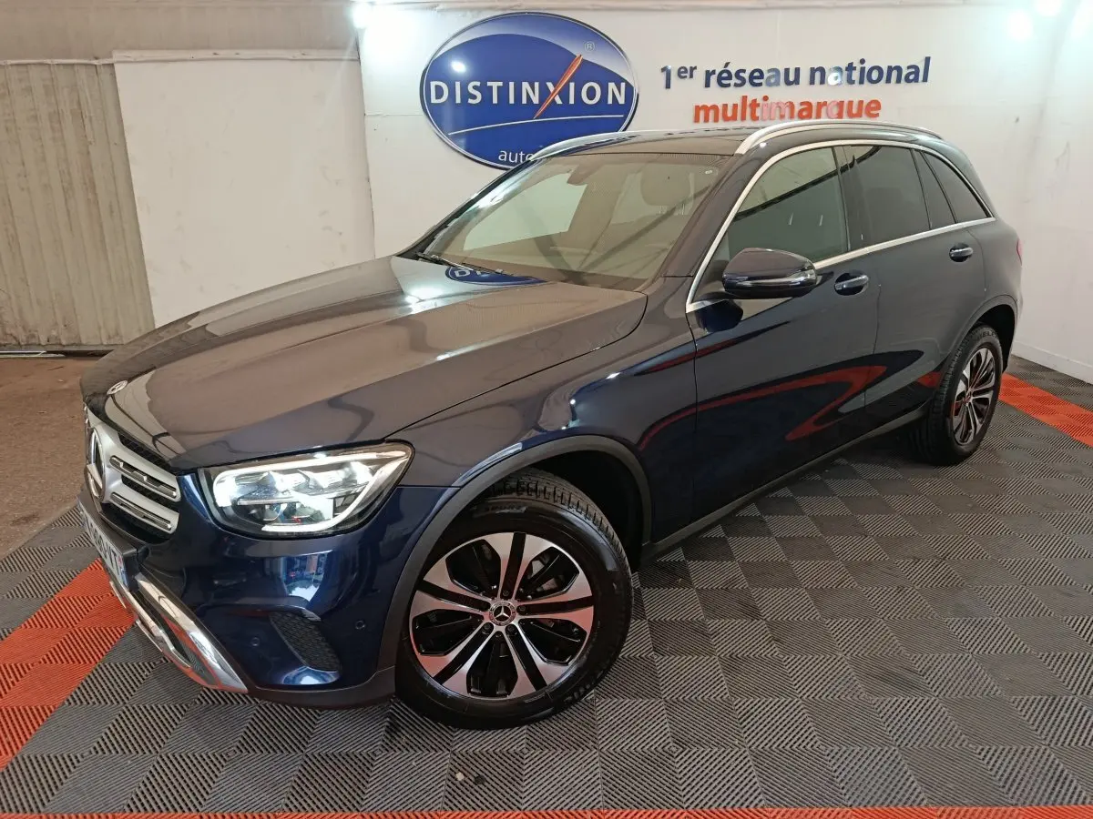 Mercedes GLC 300 E Business Line bleu, vue 3/4 avant droit, avec jantes alliage et phares LED allumés.