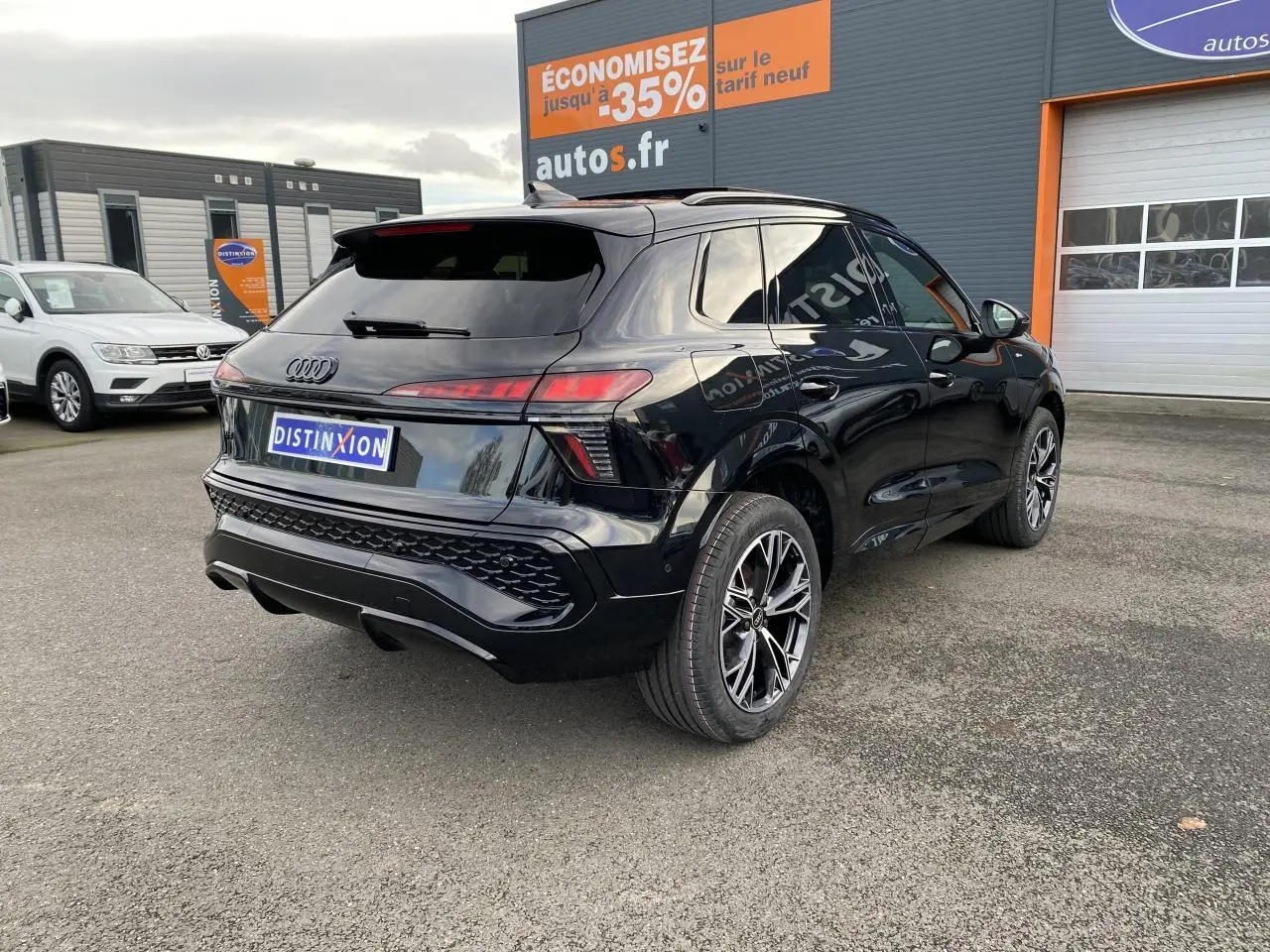 Audi Q3 noir mythic métallisé vue 3/4 arrière droit avec jantes sport noires et vitres surteintées