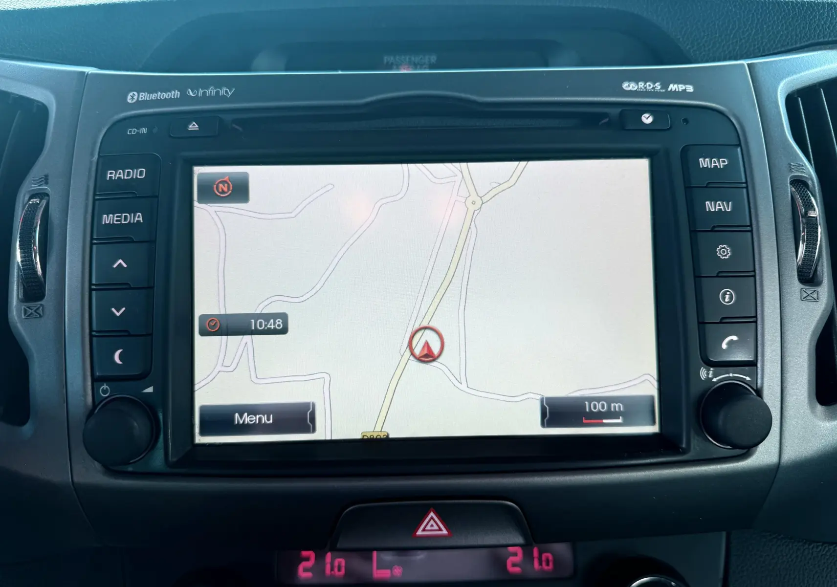 Écran de navigation tactile du Kia Sportage 2015 affichant une carte, avec commandes radio et climatisation intégrées.