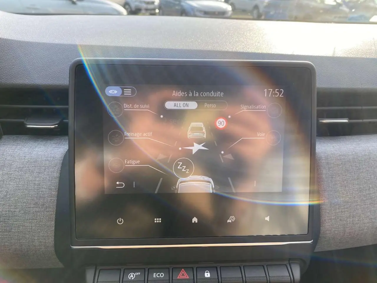 Écran tactile central de la Renault Clio 1.5 Blue dCi 2025 montrant les aides à la conduite, intérieur gris clair.