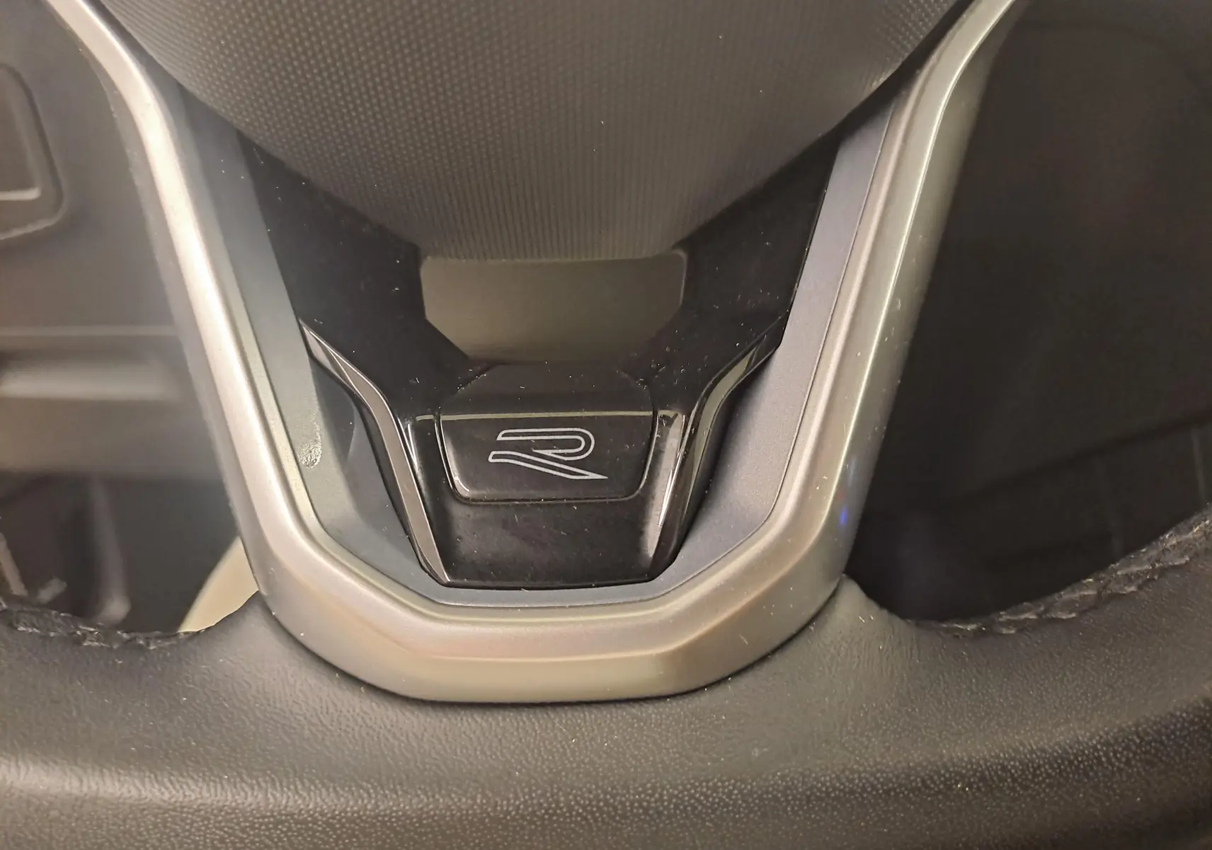 Gros plan sur le volant noir avec logo R du Volkswagen Tiguan 1.4 eHybrid 245 DSG6 R-LINE 2023.