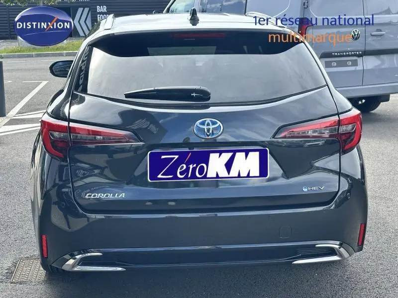 Vue arrière d'une Toyota Corolla noire 2025 hybride avec feux arrière LED et logo e-HEV visible.