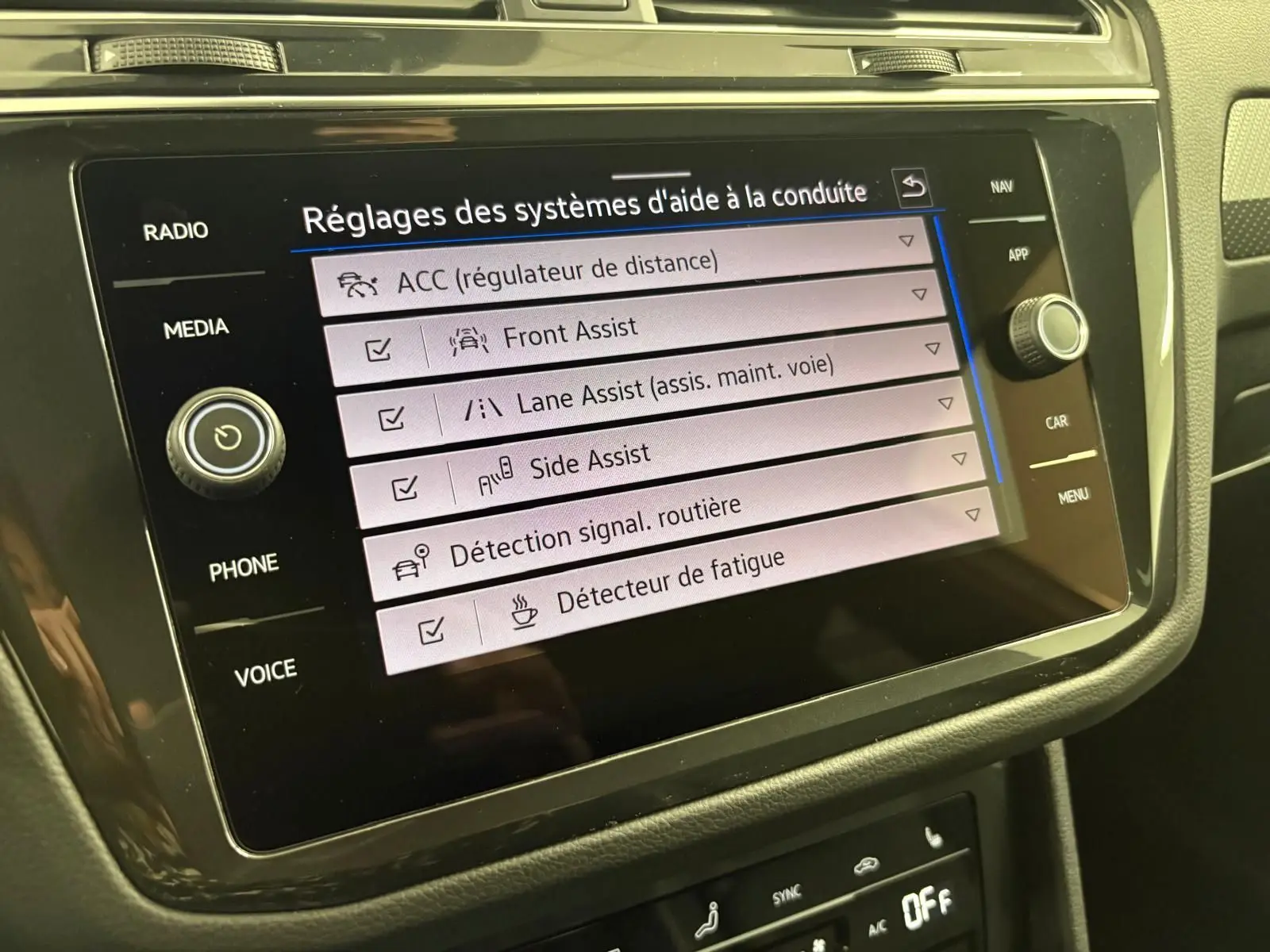 Écran tactile du système d'aide à la conduite dans l'habitacle du Volkswagen Tiguan 1.4 eHybrid blanc, version 2023.