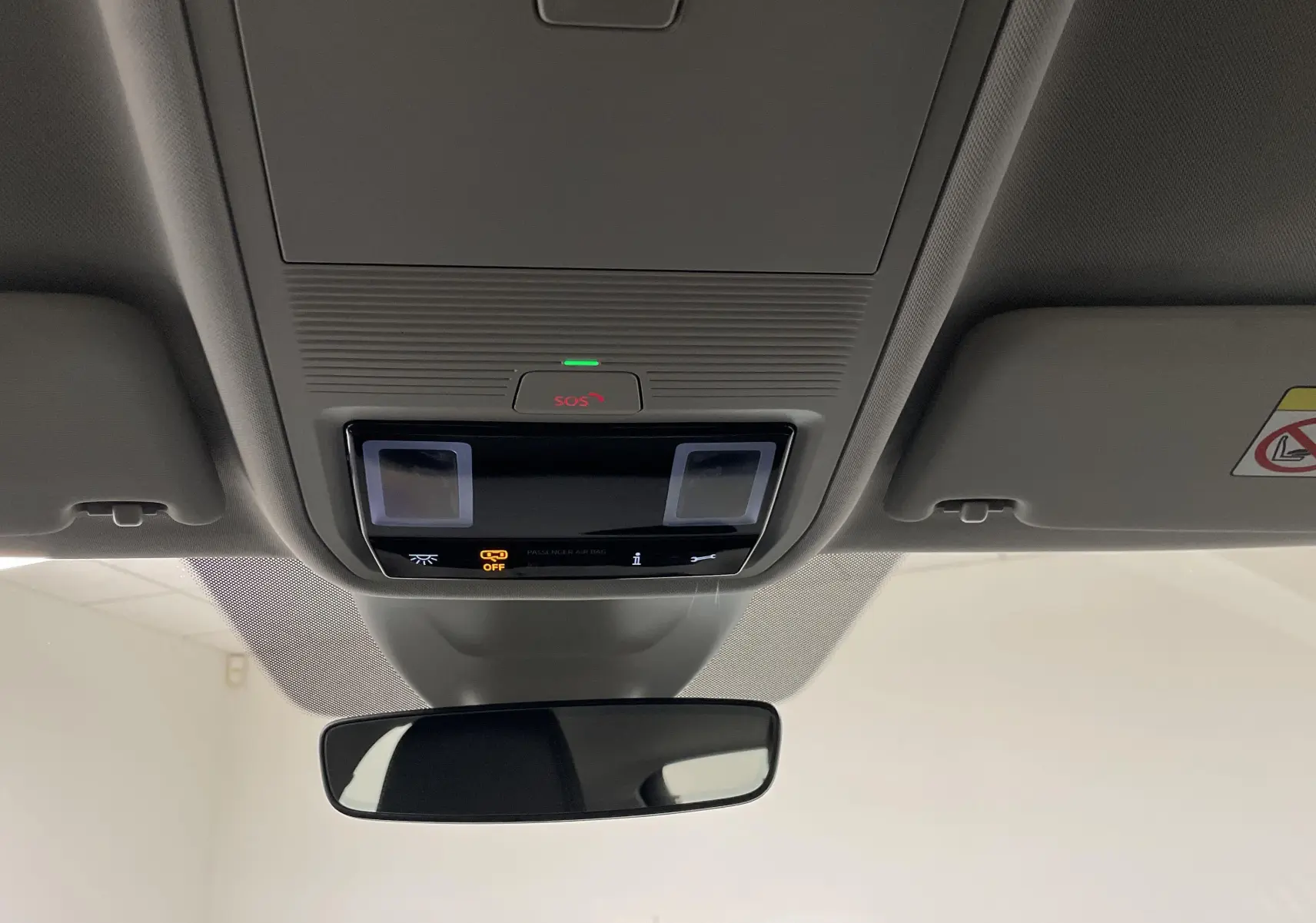 Vue intérieure du plafonnier et rétroviseur d'une Skoda Octavia 2024 avec éclairage et indicateurs SOS activés.
