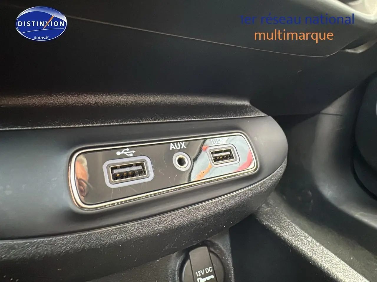 Prise USB et entrée AUX en gros plan sur la console centrale d'une Fiat 500X rouge 2020 finition Lounge