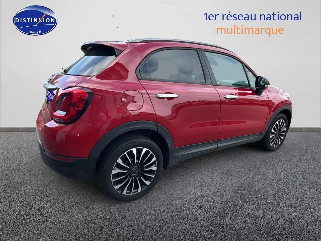 Fiat 500X rouge vue de profil côté gauche, soulignant ses jantes alliage et ses lignes compactes.