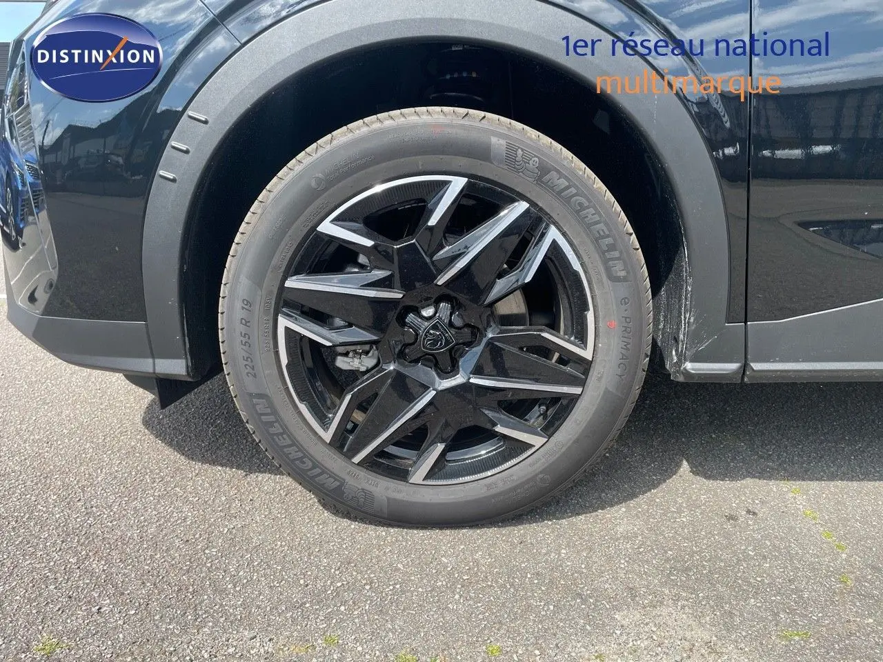 Gros plan sur la roue avant gauche du Peugeot 5008 noir perle métal avec jante alliage biton 19 pouces.