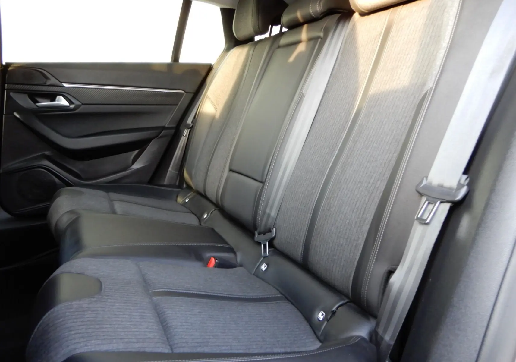 Vue latérale droite de la banquette arrière en tissu gris et cuir noir du Peugeot 508 SW noir Perla Nera 2020.