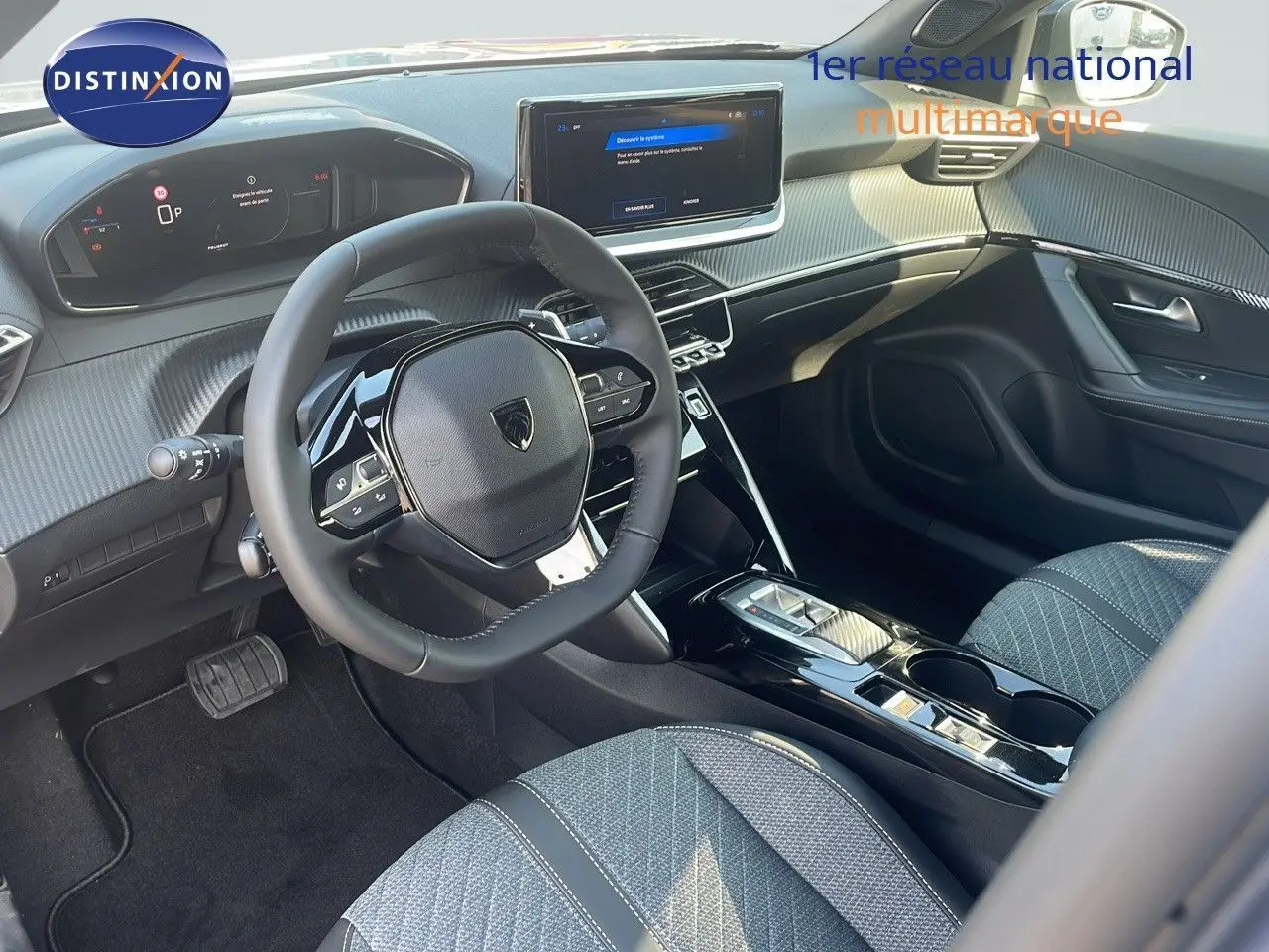 Intérieur avant droit du Peugeot 2008 Hybrid gris Artense, volant multifonction et écran tactile central lumineux.