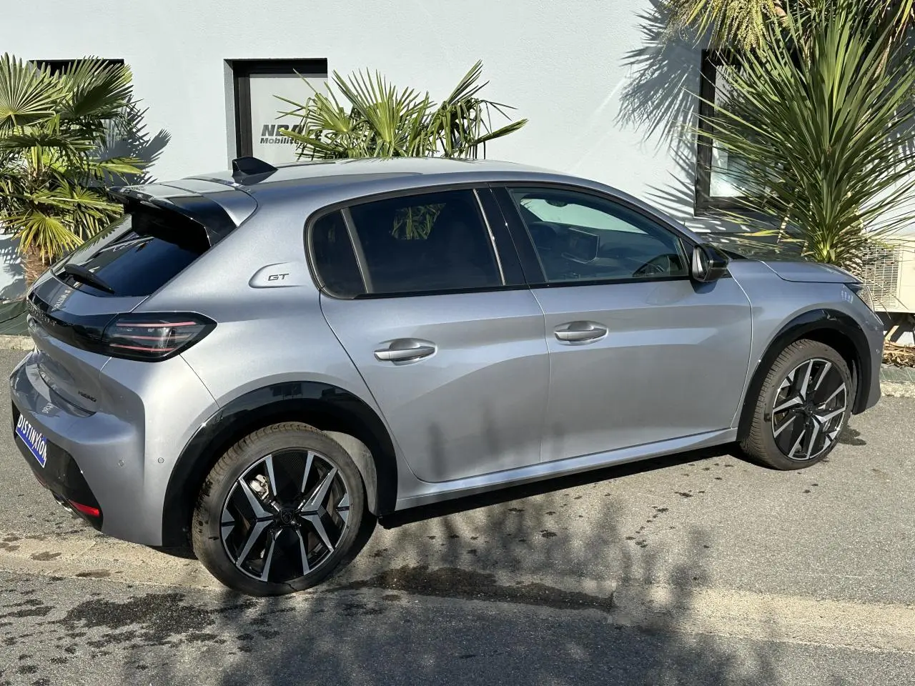 Peugeot 208 Hybrid 145 GT gris Artense vue de profil côté droit, avec jantes alliage bi-ton et badge GT arrière.